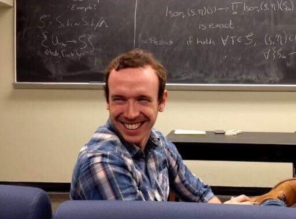 John Sheridan seated in a mathematics classroom